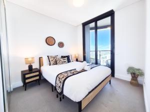 Ένα ή περισσότερα κρεβάτια σε δωμάτιο στο Horizon Suite on the TOP in Olympic Park