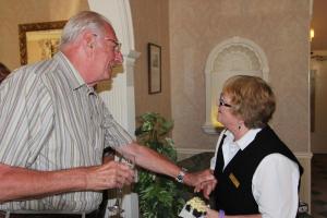 an older man and a woman standing in a room at Hunters Moon Hotel in Sidmouth