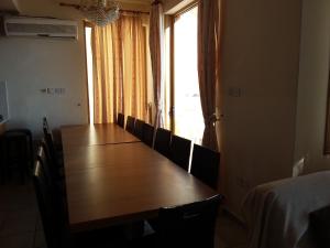a dining room table with chairs and a large window at Panoramic Seaview Villa ZEUS in Paphos +78 photos