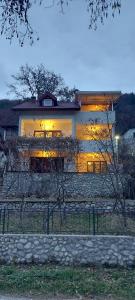 a large house with a sunset in front of it at VISIT BORACKO LAKE Apartment doelend in Jezero