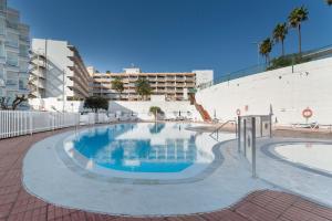 Una gran piscina con un edificio al fondo. en Estudio Yumbo Playa Del Ingles, en San Bartolomé