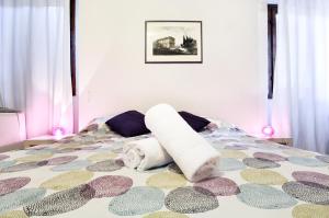 a bedroom with a bed with a comforter on it at Uffizi Apartment in Florence