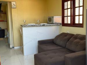 a living room with a couch and a bar at ARTE FLATS in Fortaleza