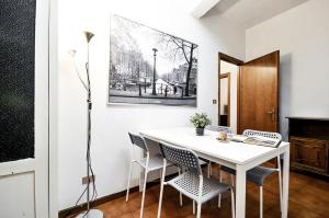a dining room with a white table and chairs at Uffizi Apartment in Florence