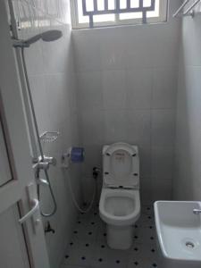 a small bathroom with a toilet and a sink at Rb cozy stay in Dodoma
