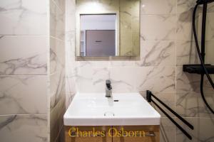 a bathroom with a white sink and a mirror at L'écume bleue du Saint-Maurice in Sète