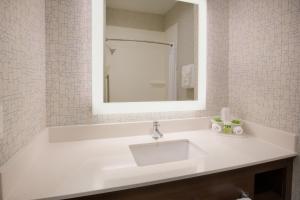 a white sink sitting under a mirror in a bathroom at Holiday Inn Express & Suites Pahrump, an IHG Hotel in Pahrump
