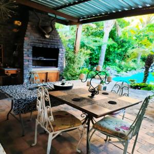 a table and chairs on a patio with a fireplace at Hidden Gem Self-catering RUWARI BRACKENFELL CAPE TOWN in Cape Town +22 photos