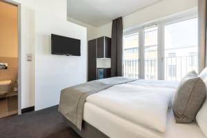 Postel nebo postele na pokoji v ubytování Garner Hotel Berlin - Mitte by IHG