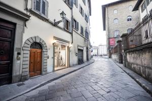 an empty street in an alley with buildings at Uffizi Apartment in Florence