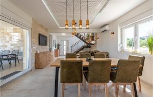 a dining room with a table and chairs at Gorgeous Home In Vrsi in Vrsi