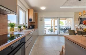 a kitchen with a view of the ocean at Gorgeous Home In Vrsi in Vrsi