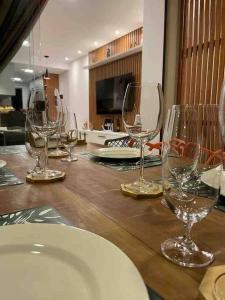 a group of wine glasses sitting on a wooden table at Paraíso da Lagoa, Praia de Itacimirim Village novo! in Itacimirim