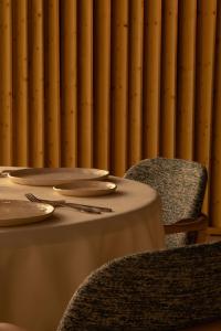 a table and chairs with plates and napkins at La Casa del Presidente Small Luxury Hotels in Ávila
