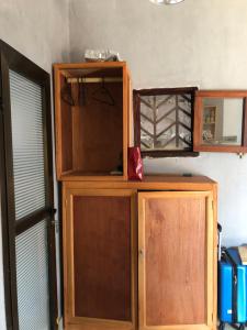 a wooden cabinet in a room with a window at Brazzaville agréable Studio, Square Home Heart in Brazzaville