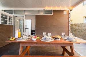 a wooden table with food on top of it at Host Wise - Charming Cozy Rooms in São Mamede de Infesta