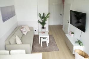 a living room with a couch and a table at SI apartments - Smart Inn in Vienna