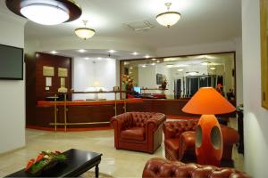 a lobby with leather chairs and a waiting room at Hotel Citrin - Adults Only in Braşov