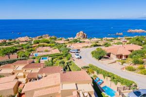 an aerial view of a village with the ocean at Villa Lumière in Costa Paradiso