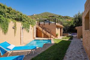 a backyard with a swimming pool and a house at Villa Lumière in Costa Paradiso +34 photos