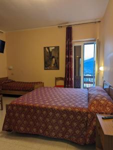 a hotel room with a bed and a balcony at Albergo Seggiovia in Scanno