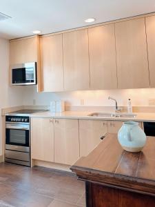 a kitchen with a vase sitting on a wooden table at 1 bed apartment with parking - Denver Museum District Walk to Convention Center, Capital, museums and shops in Denver