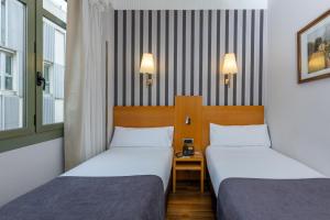 Postel nebo postele na pokoji v ubytování Hotel Lyon