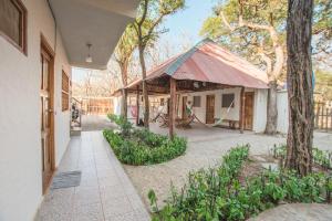 an outside view of a building with a hammock outside at The Ceiba House in Rivas