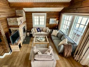 an overhead view of a living room with a couch and a tv at Large family cabin in Hafjell ski in-out, BBQ, terrace and fireplace in Hafjell