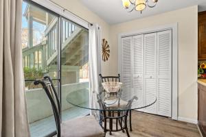 a dining room with a glass table and a balcony at Dry Dock 101 in Myrtle Beach