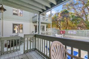 a balcony with a chair and a house at Dry Dock 101 in Myrtle Beach
