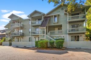 a large apartment building with balconies and trees at Dry Dock 101 in Myrtle Beach