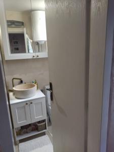 a bathroom with a sink and a white cabinet at Sumski raj-Zvezdara in Belgrade