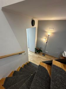 a bedroom with a bed and a room with a lamp at Duplex Moderno Perto da Praia in Armação de Pêra +13 photos