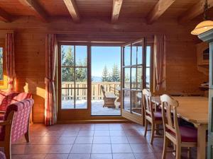 a dining room with a table and a large window at 1A Chalet Koralpenglück Wandern, Grillen und Indoor Sauna in Elsenbrunn +58 photos