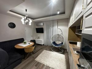 a living room with a couch and a table at City apartments in Satu Mare