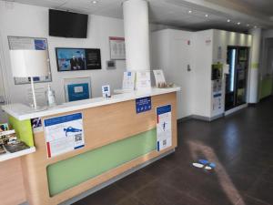 a store with a counter with signs on it at Ibis Budget Marseille Valentine in Marseille