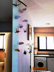 a kitchen with a wall with fish on it at Eli's Home in Málaga +3 photos
