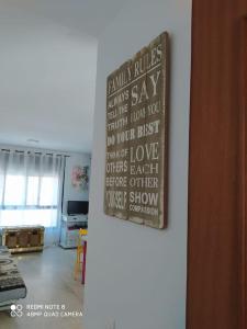 a sign hanging on a wall in a room at Eli's Home in Málaga