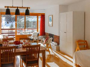 a living room with a dining room table and chairs at Apartment Rosablanche A21 by Interhome in Siviez