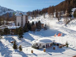 a ski resort in the snow with a building at Apartment Rosablanche A21 by Interhome in Siviez