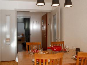 a dining room and kitchen with a table and chairs at Apartment Rosablanche A21 by Interhome in Siviez +22 photos