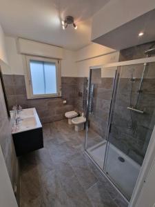 a bathroom with a shower and a sink and a toilet at Domus Milano sul Naviglio-Free Parking-NoCityTax in Trezzano sul Naviglio +22 photos
