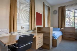 a bedroom with a bed and a desk at LSE Passfield Hall in London