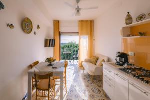 a kitchen and living room with a table and chairs at Appartamento Mare Blu in Sciacca