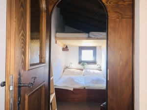 an open door to a bedroom with a bunk bed at Apartment Residenza Chesa Margun 59-6 by Interhome in Surlej +17 photos