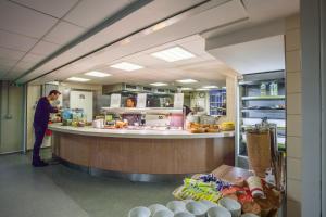 a man standing at a counter in a kitchen at LSE Passfield Hall in London