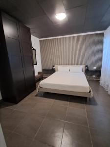 a bedroom with a white bed in a room at Corinna family in Casal Palocco