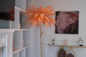 a palm tree in a corner of a room at GRAND 200 SqM 3-Bedroom VILLA in London +37 photos