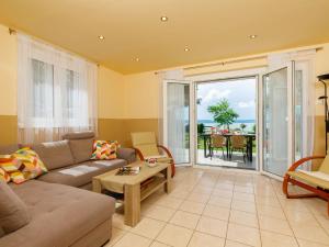 a living room with a couch and a table at Holiday Home Hanna by Interhome in Balatonlelle